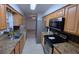 Galley kitchen with stainless steel appliances and light brown cabinets at 5379 Ne 11Th Ave, Ocala, FL 34479