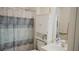 Clean bathroom with shower/tub and storage cabinet at 5622 Sir Churchill Dr, Leesburg, FL 34748