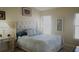 Spacious bedroom with a comfortable bed and neutral decor at 5622 Sir Churchill Dr, Leesburg, FL 34748