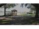 Wooden gazebo overlooking a lake with walking path at 5622 Sir Churchill Dr, Leesburg, FL 34748