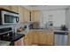 Bright kitchen with stainless steel appliances and granite countertops at 5622 Sir Churchill Dr, Leesburg, FL 34748