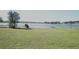 Lakefront view with grassy area and trees at 5622 Sir Churchill Dr, Leesburg, FL 34748