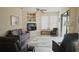 Living room with grey couch and built-in shelving at 5622 Sir Churchill Dr, Leesburg, FL 34748