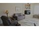 Living room with grey couch and built-in shelving at 5622 Sir Churchill Dr, Leesburg, FL 34748