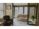 Relaxing sunroom with a recliner and potted plant at 5622 Sir Churchill Dr, Leesburg, FL 34748