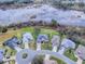 Aerial view of homes on a cul-de-sac near a lake at 5626 Squires Dr, Leesburg, FL 34748