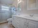 Elegant bathroom with double vanity, glass shower, and tile flooring at 5626 Squires Dr, Leesburg, FL 34748