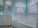Bright bathroom with double vanity, corner soaking tub, and natural light at 5626 Squires Dr, Leesburg, FL 34748