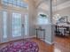 Elegant entryway with hardwood floors, a formal dining area, and stained glass door at 5626 Squires Dr, Leesburg, FL 34748