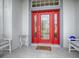 Inviting red front door with glass panels and a welcoming mat at 5626 Squires Dr, Leesburg, FL 34748