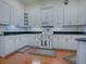 Well-equipped kitchen features white cabinets, granite countertops, and ample storage at 5626 Squires Dr, Leesburg, FL 34748
