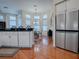 Modern kitchen with white cabinets, breakfast nook, and stainless steel refrigerator at 5626 Squires Dr, Leesburg, FL 34748