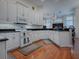 Spacious kitchen boasts white cabinets, granite countertops, and stainless steel appliances at 5626 Squires Dr, Leesburg, FL 34748