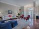 Living room with hardwood floors, plush seating, and access to backyard at 5626 Squires Dr, Leesburg, FL 34748