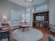 Bright living room with hardwood floors, built-in entertainment center, and comfortable seating at 5626 Squires Dr, Leesburg, FL 34748