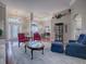 Spacious living room with hardwood floors, comfortable seating, and large windows at 5626 Squires Dr, Leesburg, FL 34748