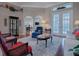Living room with hardwood floors, comfortable seating, and French doors to patio at 5626 Squires Dr, Leesburg, FL 34748