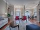 Bright living room with hardwood floors, comfy seating, and a view to the entry at 5626 Squires Dr, Leesburg, FL 34748