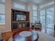 Spacious living room featuring hardwood floors, large windows, and access to a screened porch at 5626 Squires Dr, Leesburg, FL 34748