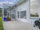 Spacious patio with screened enclosure, leading to a lush backyard at 5626 Squires Dr, Leesburg, FL 34748