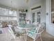 Relaxing sunroom with glass top table and seating area at 5626 Squires Dr, Leesburg, FL 34748