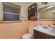 Bathroom with tile walls, a vanity sink, and toilet at 6100 Windmill Rd, Leesburg, FL 34748