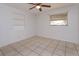 Bright, empty bedroom featuring tile floors and white walls at 6100 Windmill Rd, Leesburg, FL 34748