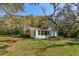 Charming single-story home with mature trees and screened porch, perfect for relaxing and enjoying the outdoors at 6100 Windmill Rd, Leesburg, FL 34748