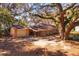 Charming single-story home featuring a detached garage and a spacious front yard shaded by mature oak trees at 6100 Windmill Rd, Leesburg, FL 34748