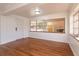 Bright and airy living room featuring laminate floors, white walls, large windows, and natural light throughout at 6100 Windmill Rd, Leesburg, FL 34748