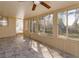 Sunroom filled with light through windows offering views of the backyard at 6100 Windmill Rd, Leesburg, FL 34748
