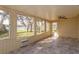 Sunroom with multiple windows offering views of the surrounding nature at 6100 Windmill Rd, Leesburg, FL 34748