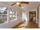 Bright sunroom with tile flooring and windows offering scenic views at 6100 Windmill Rd, Leesburg, FL 34748