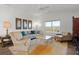 Comfortable living room featuring a sectional sofa and large windows at 6182 Dingman Way, The Villages, FL 32163