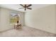 Well-lit bedroom with ceiling fan and neutral decor at 804 Forest Breeze Path, Leesburg, FL 34748