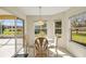 Breakfast nook with glass table and chairs, looking out to backyard at 804 Forest Breeze Path, Leesburg, FL 34748