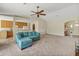 Open living room with teal sectional sofa and view of kitchen at 804 Forest Breeze Path, Leesburg, FL 34748