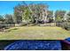 Large backyard with grass and brick patio at 8065 Penrose Pl, Wildwood, FL 34785