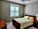 Well-lit bedroom with a comfortable bed and plenty of closet space at 8065 Penrose Pl, Wildwood, FL 34785
