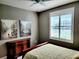 Spacious bedroom with large window, dresser, and comfortable bed at 8065 Penrose Pl, Wildwood, FL 34785