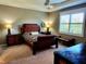 Spacious bedroom with a comfortable bed, nightstands, and ample natural light at 8065 Penrose Pl, Wildwood, FL 34785