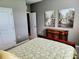 Bright bedroom with large window, dresser and comfortable bed at 8065 Penrose Pl, Wildwood, FL 34785