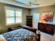 Relaxing bedroom with large window, dresser, and comfortable bed at 8065 Penrose Pl, Wildwood, FL 34785