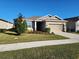 Charming one-story house with a well-manicured lawn and two-car garage at 8065 Penrose Pl, Wildwood, FL 34785