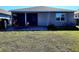 Rear view of house with patio and lawn at 8065 Penrose Pl, Wildwood, FL 34785