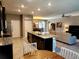 Modern kitchen with granite counters, island, and stainless steel appliances at 8065 Penrose Pl, Wildwood, FL 34785