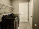 Bright laundry room with washer, dryer, and shelving at 8065 Penrose Pl, Wildwood, FL 34785