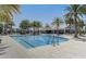 Resort-style pool with palm trees, sundeck and clubhouse offers residents a relaxing, vacation-like escape at 8065 Penrose Pl, Wildwood, FL 34785