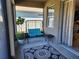 Cozy screened patio with swing and small table at 8065 Penrose Pl, Wildwood, FL 34785