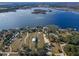 Wide aerial view of lakefront property and land at 8415 Colony Barn Rd, Clermont, FL 34714